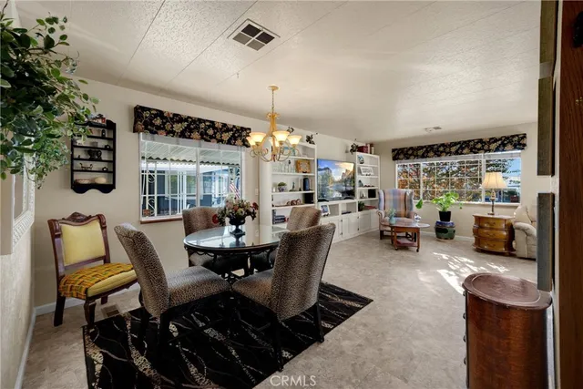 a dining room with furniture and a chandelier