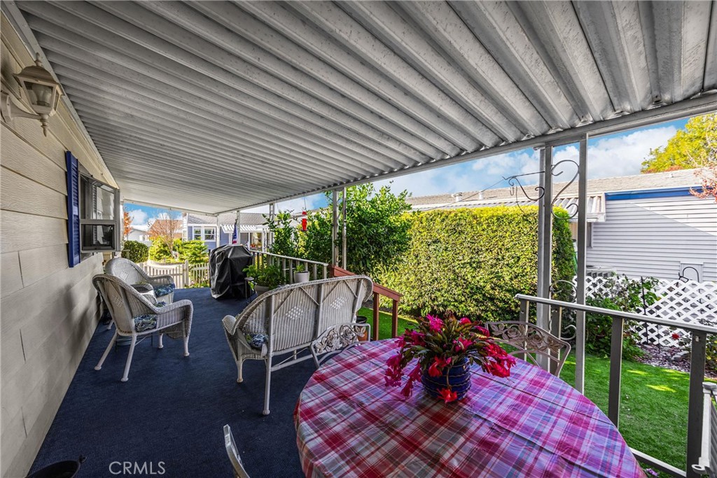 10210 Base Line Road, Unit 235 Rancho Cucamonga, CA 91701 - Photo 27 of 33 a view of a patio with table and chairs potted plants with wooden floor and fence