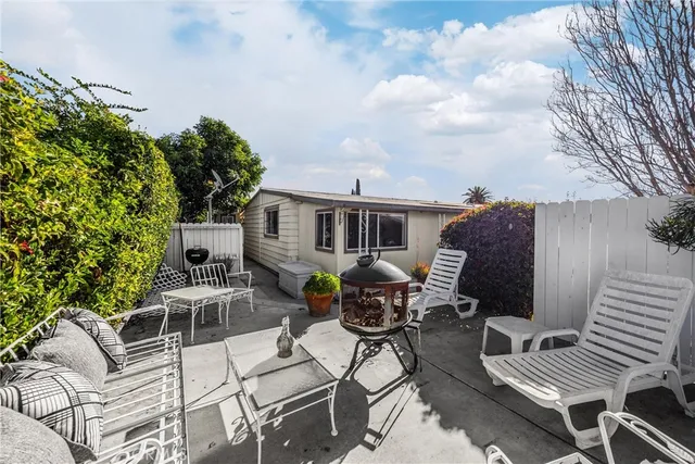 a view of a patio with table and chairs and potted plants