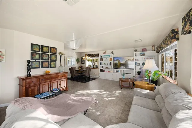 a living room with furniture and a book shelf