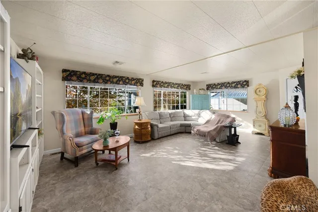 a bedroom with furniture and a large window