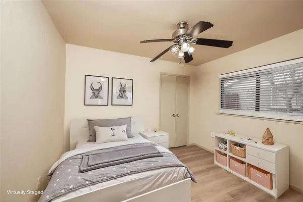 a bedroom with a large bed and a window