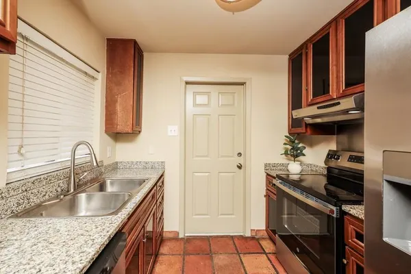 a kitchen with a sink stove and refrigerator