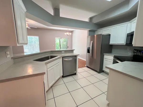 a kitchen with a sink a stove and refrigerator
