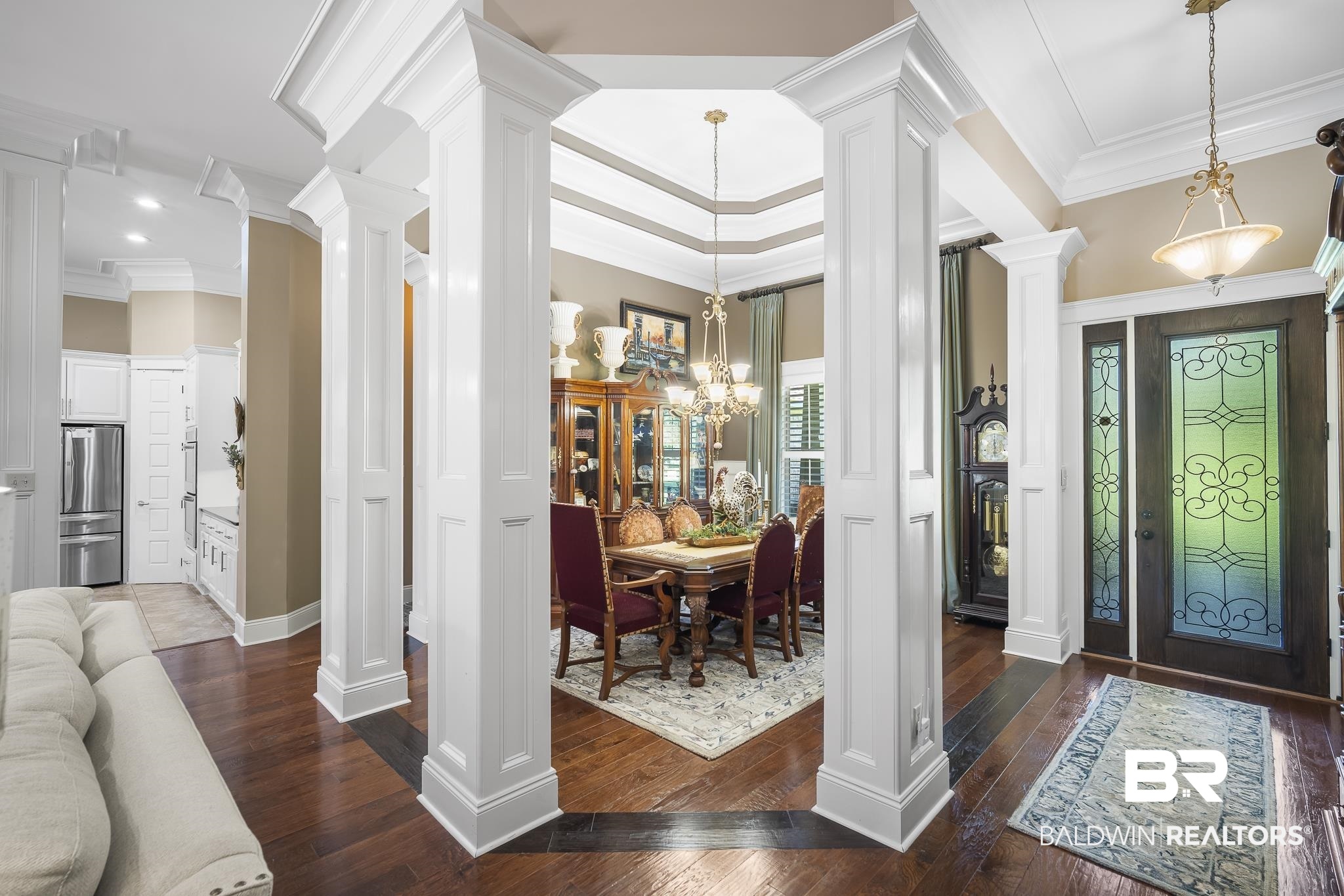 25212 Austin Road Daphne, AL 36526 - Photo 11 of 56 Entryway featuring a chandelier, ornamental molding, dark wood-style floors, and ornate columns
