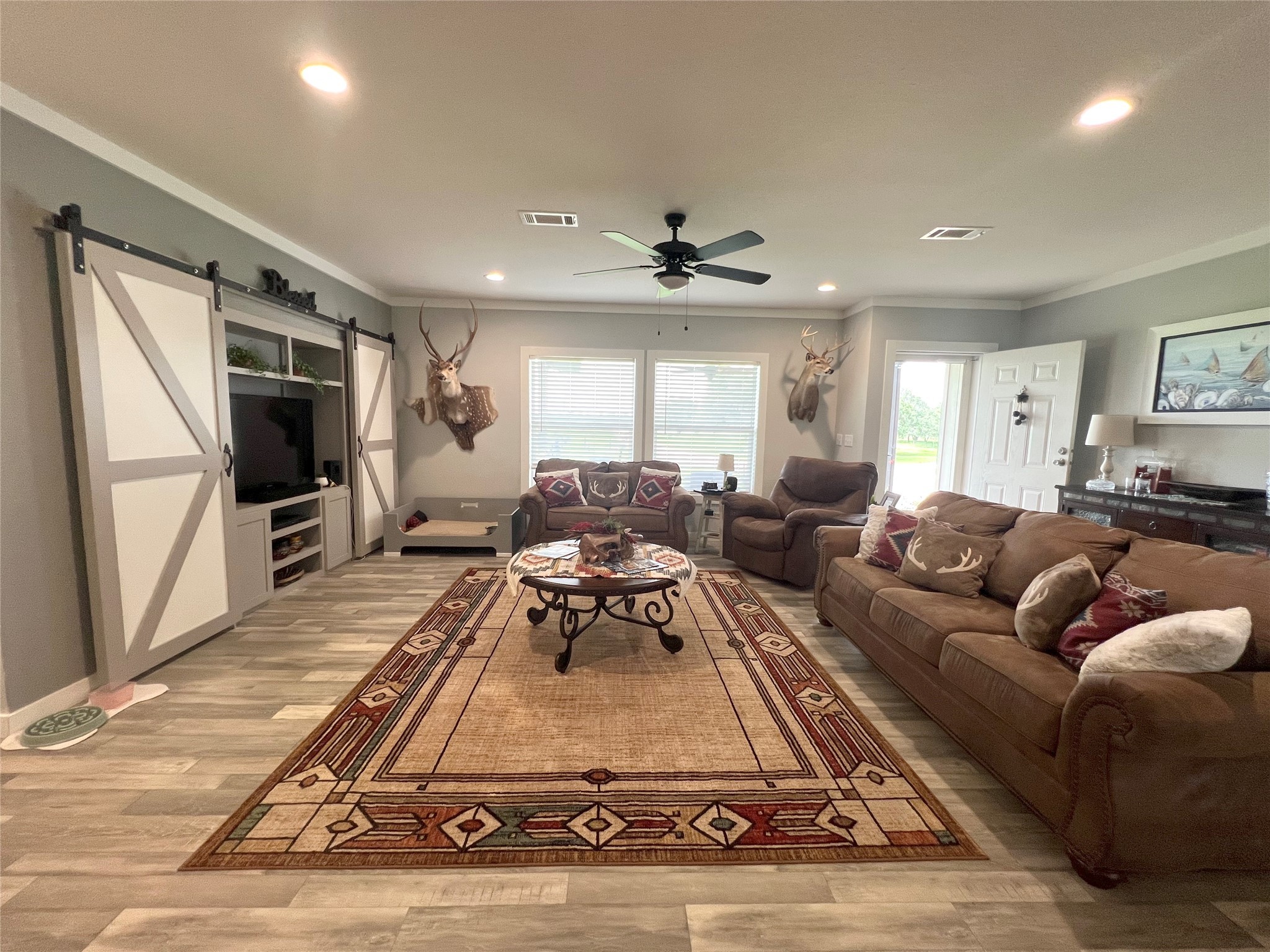 7391 FM 2546 Road El Campo, TX 77437 - Photo 13 of 50 a living room with furniture a large window and a flat screen tv