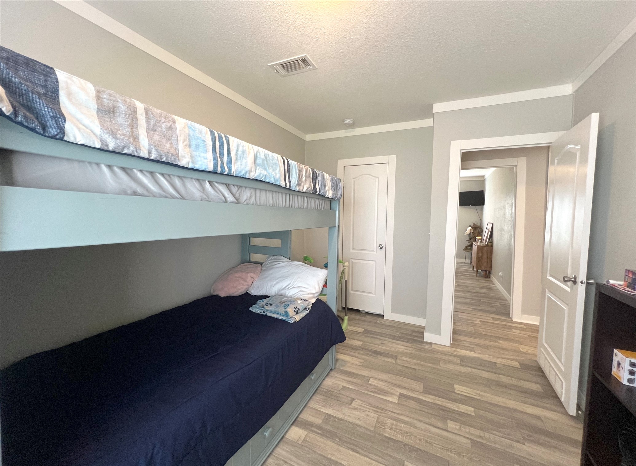 7391 FM 2546 Road El Campo, TX 77437 - Photo 24 of 50 a bedroom with a bed and wooden floor