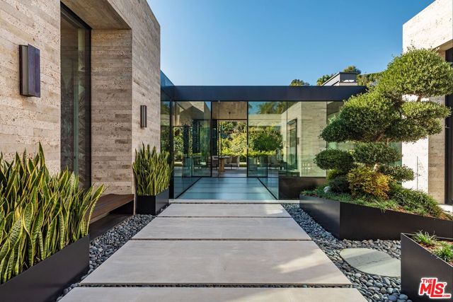 a view of a patio with couches and potted plants