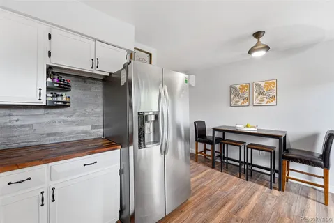 a kitchen with stainless steel appliances granite countertop a refrigerator and a stove top oven