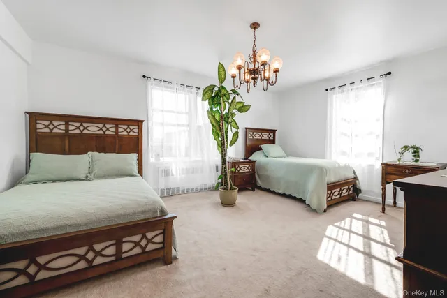 a bed room with furniture and a chandelier