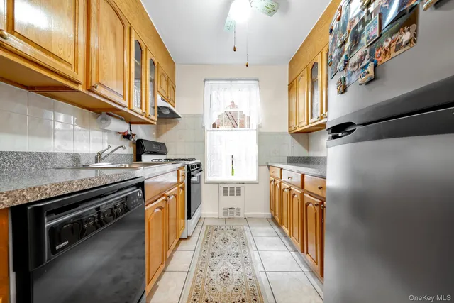 a kitchen with stainless steel appliances granite countertop a stove and a microwave
