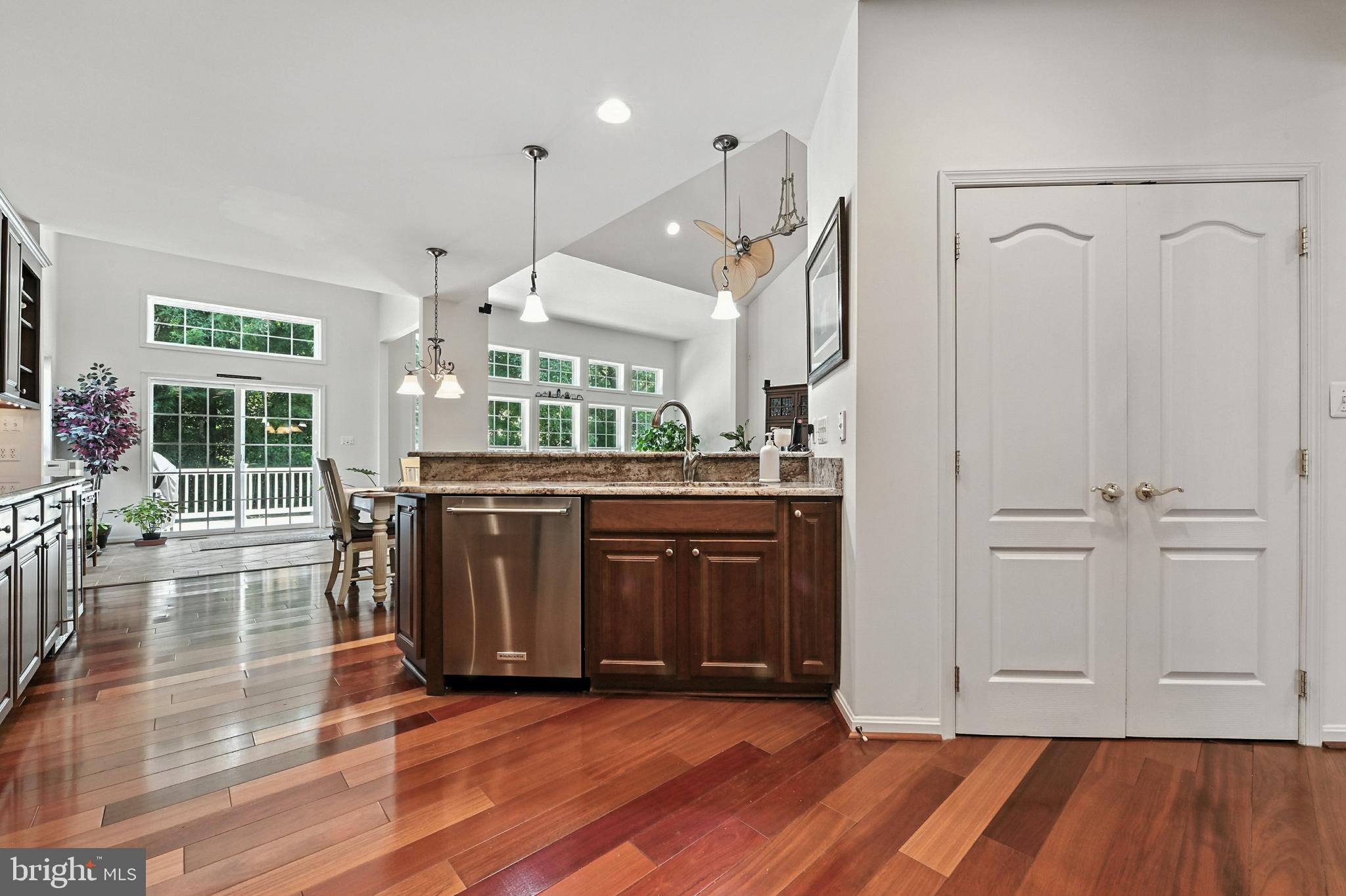 371 Overture Way Centreville, MD 21617 - Photo 11 of 68 a kitchen with stainless steel appliances granite countertop a stove a sink and a refrigerator with wooden floor