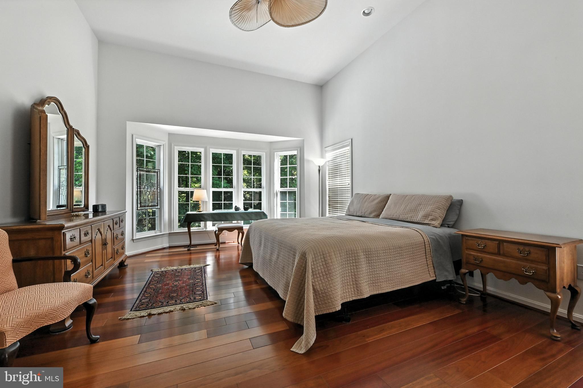 371 Overture Way Centreville, MD 21617 - Photo 19 of 68 a spacious bedroom with a bed a couch and large window