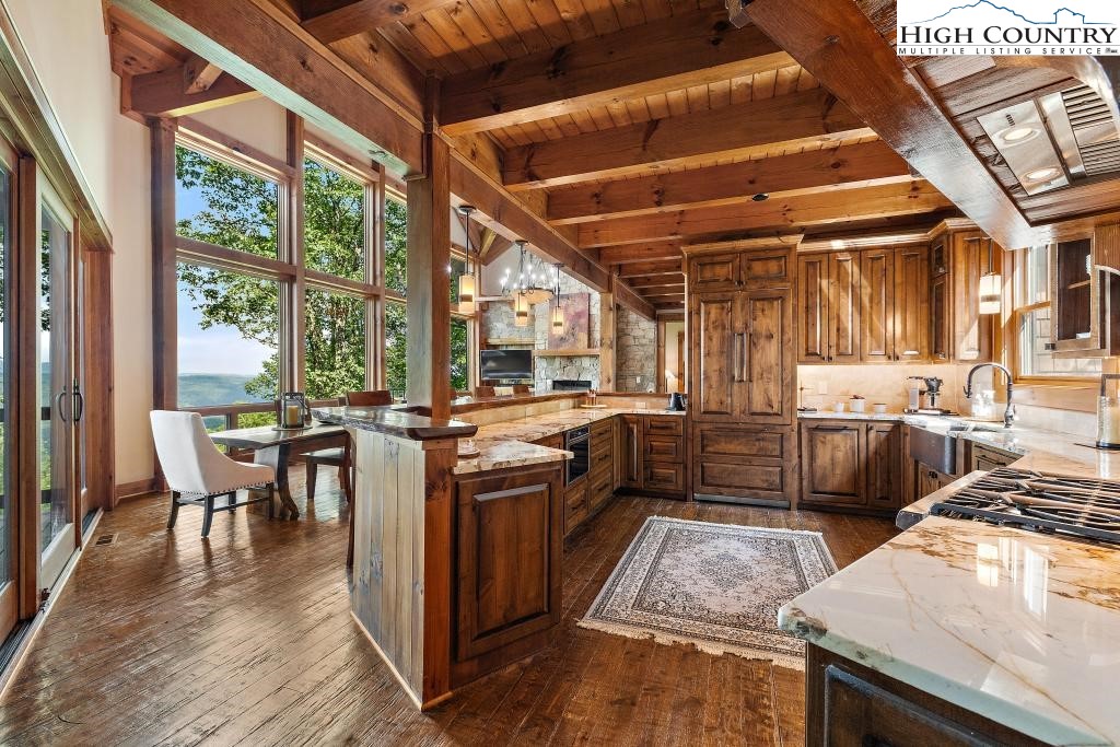 711 Goldenrod Road Boone, NC 28607 - Photo 12 of 49 a kitchen with stainless steel appliances granite countertop sink stove top oven and cabinets