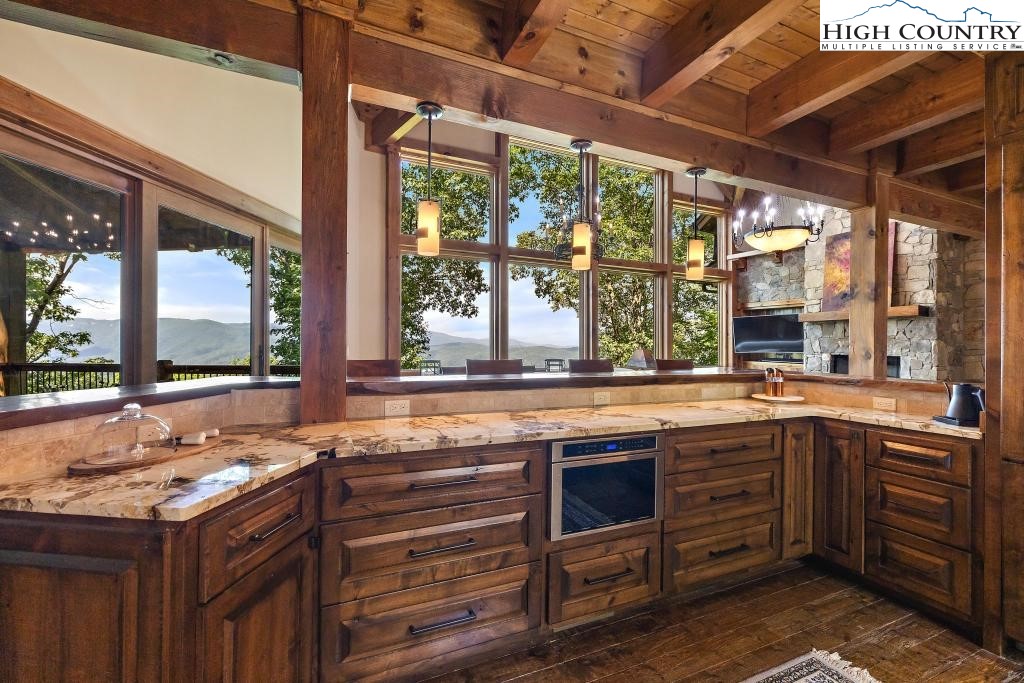 711 Goldenrod Road Boone, NC 28607 - Photo 13 of 49 a kitchen with a sink and large wooden cabinets
