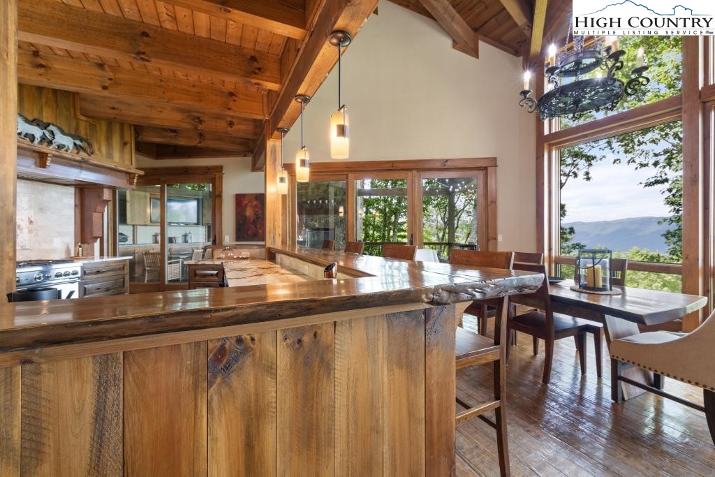 711 Goldenrod Road Boone, NC 28607 - Photo 14 of 49 a dining hall with stainless steel appliances kitchen island a table and chairs in it