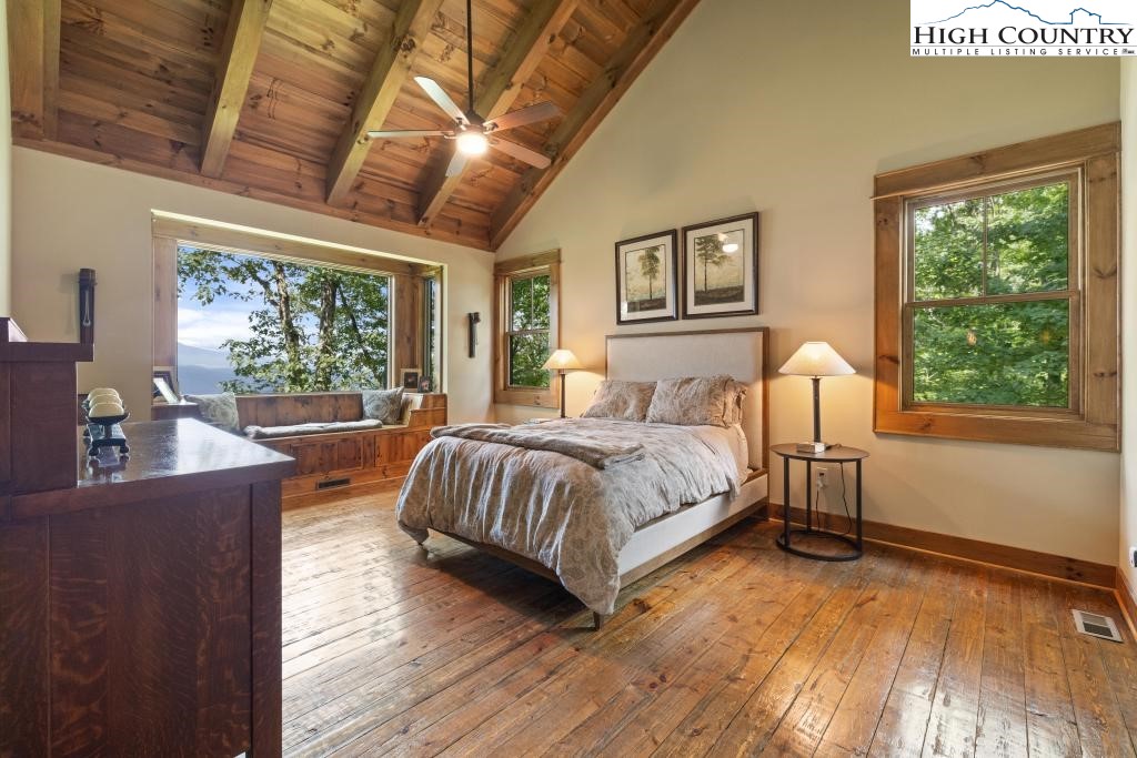 711 Goldenrod Road Boone, NC 28607 - Photo 19 of 49 a bedroom with a large bed and a large window