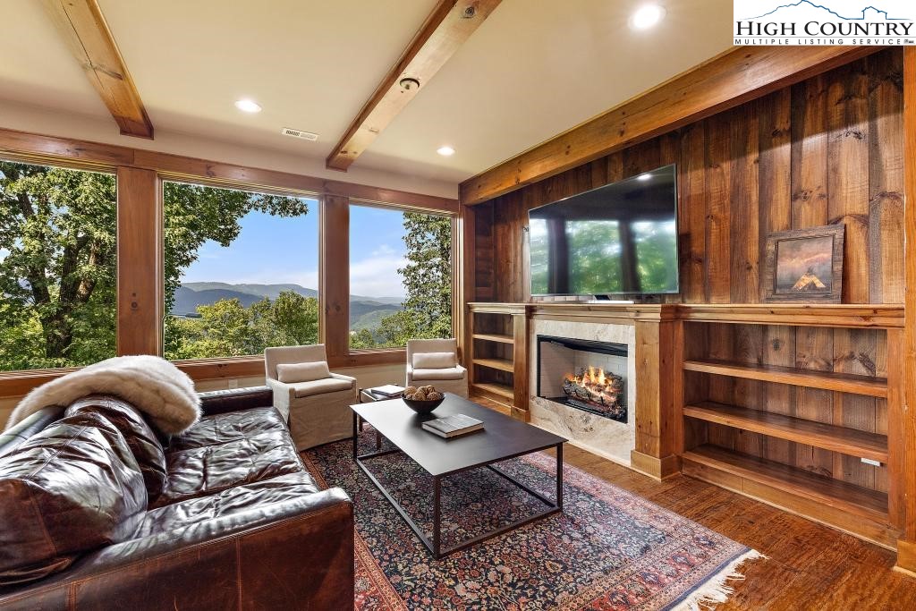711 Goldenrod Road Boone, NC 28607 - Photo 29 of 49 a living room with furniture fireplace and a large window