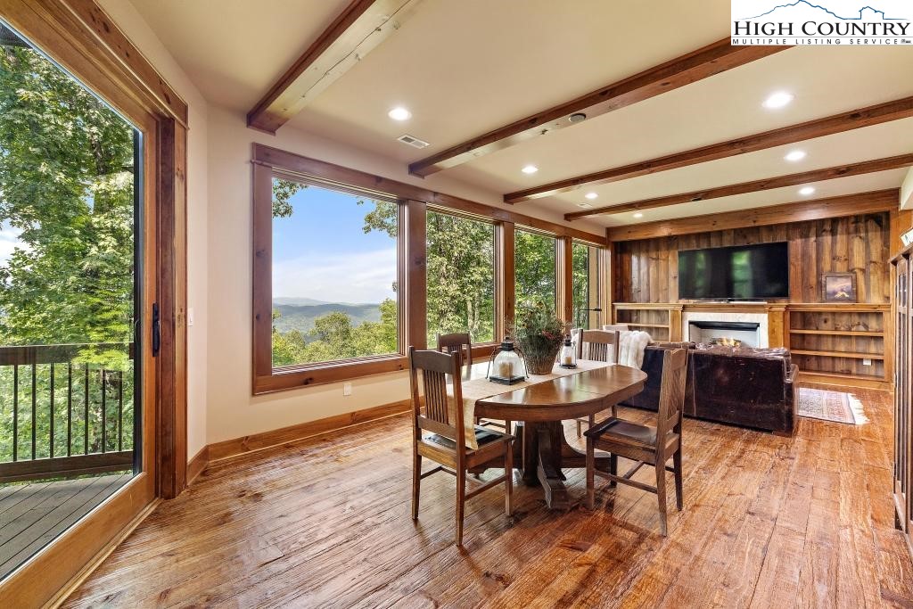 711 Goldenrod Road Boone, NC 28607 - Photo 30 of 49 a dining room with furniture window and wooden floor