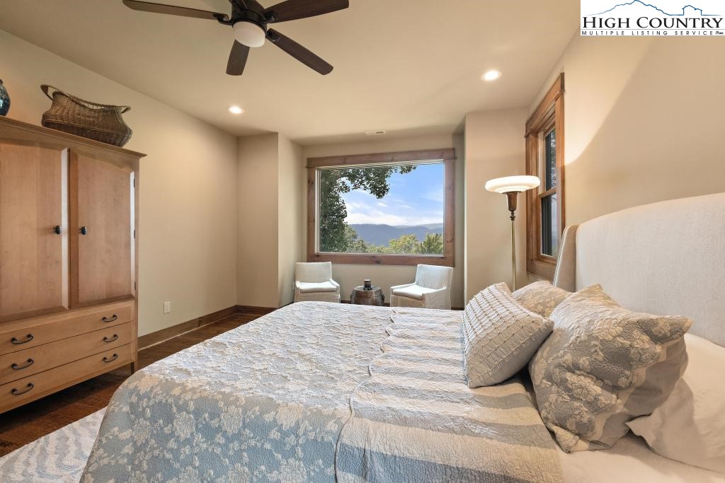 711 Goldenrod Road Boone, NC 28607 - Photo 39 of 49 a bedroom with a large bed and a flat tv screen on dresser