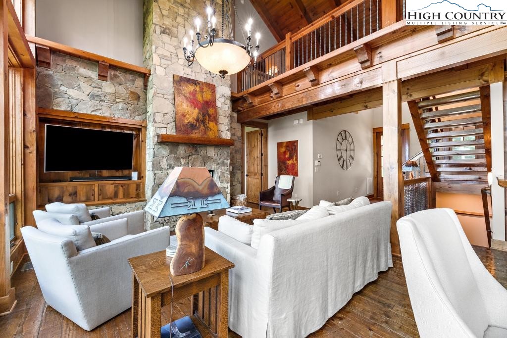 711 Goldenrod Road Boone, NC 28607 - Photo 6 of 49 a living room with furniture a flat screen tv and kitchen view