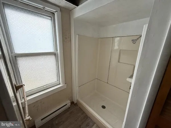 a bathroom with a glass door shower and a sink