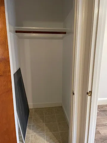 an empty room with wooden floor and door