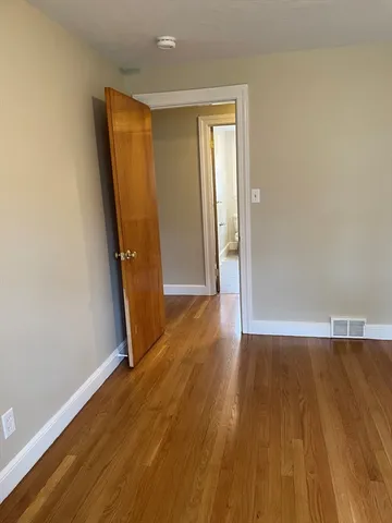 a bathroom with a granite countertop toilet sink and mirror