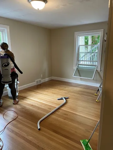 an empty room with wooden floor and closet