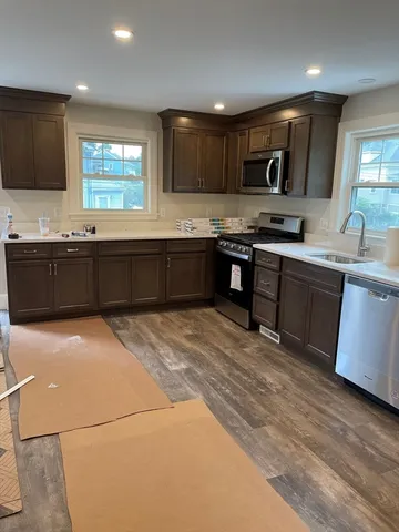 a view of a room with wooden floor and window
