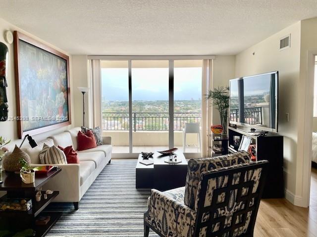3232 Southwest 22nd Terrace, Unit 1303 Miami, FL 33145 - Photo 5 of 43 a living room with furniture and a large window