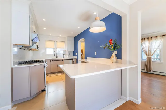 a kitchen with stainless steel appliances granite countertop a stove a sink and a microwave