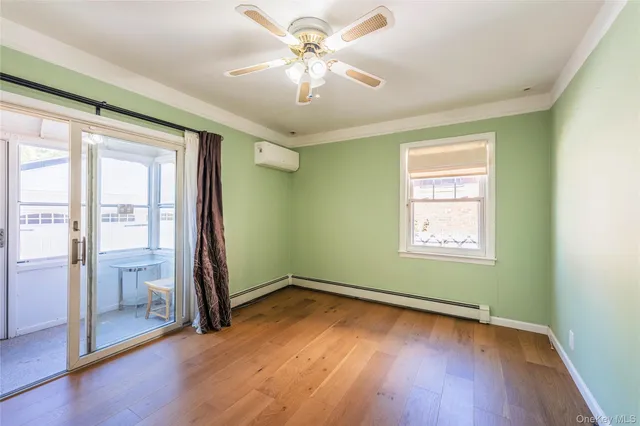 a view of a hallway with windows chandelier front door