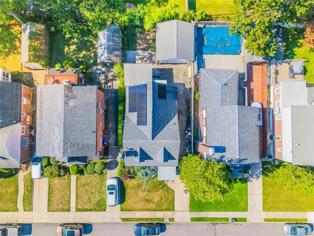a view of a house with a tree and pathway