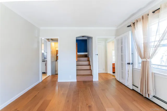 a view of a hallway with wooden staircase and stairs