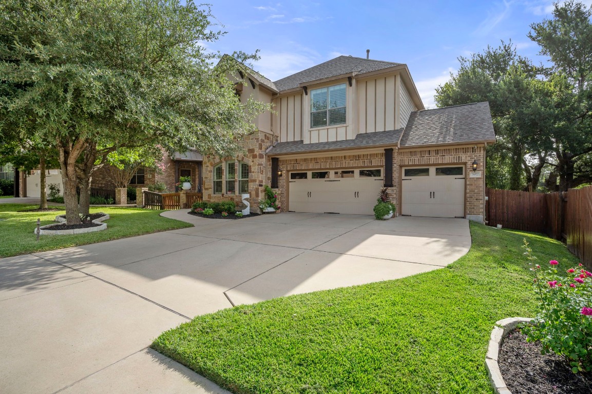 a front view of a house with a yard and trees