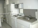 100 Lincoln Road, Unit 314A Miami Beach, FL 33139 - Photo 15 of 40 a kitchen with a sink and a stove top oven