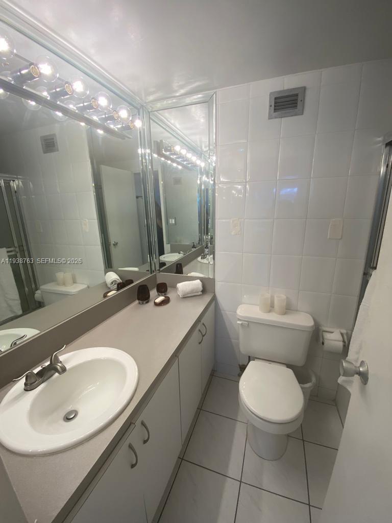 100 Lincoln Road, Unit 314A Miami Beach, FL 33139 - Photo 16 of 40 a bathroom with a sink toilet and shower