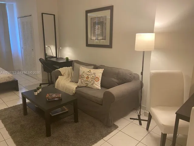 a living room with furniture and a lamp