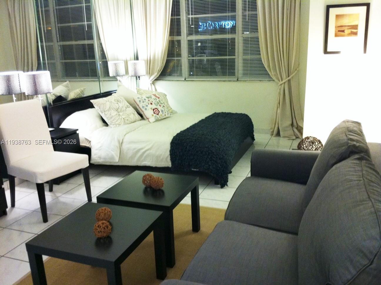 100 Lincoln Road, Unit 314A Miami Beach, FL 33139 - Photo 5 of 40 a living room with furniture and a window