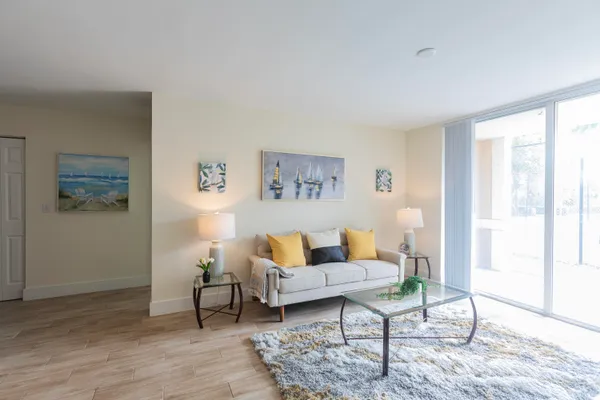 a living room with furniture and wooden floor
