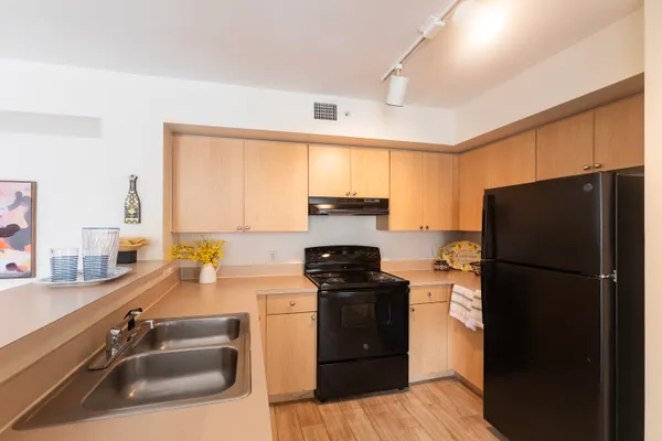 a kitchen with a refrigerator stove and sink