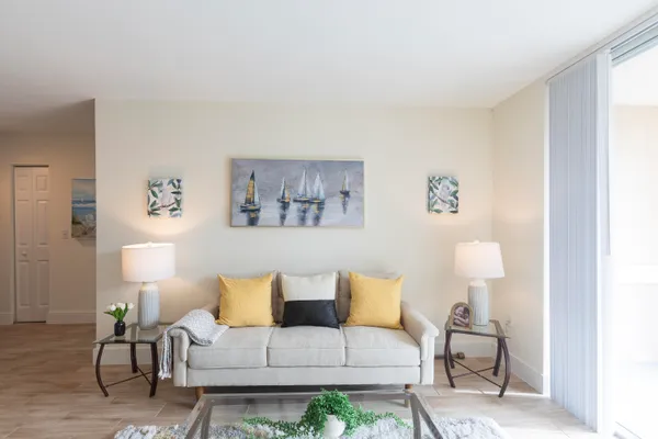 a living room with furniture and a lamp