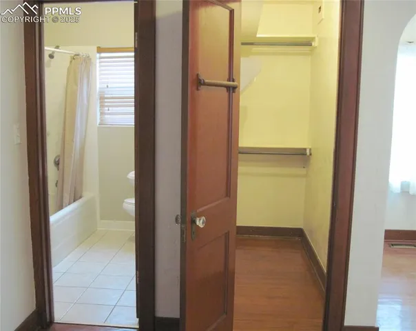 a view of a hallway with wooden floor