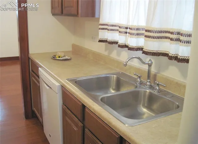 a kitchen with a white cabinets and a refrigerator