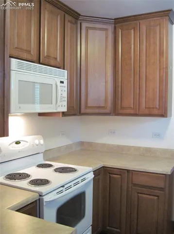 a kitchen with a stove cabinets and wooden floor