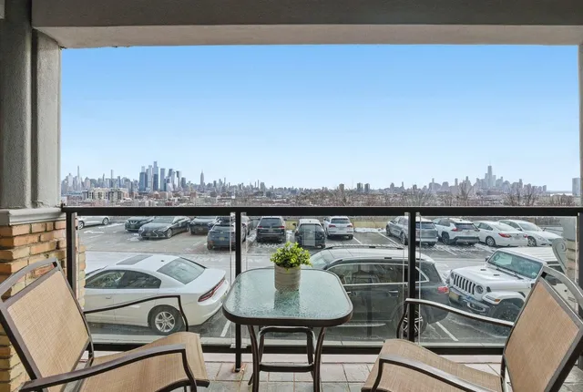 a view of a balcony with table and chairs