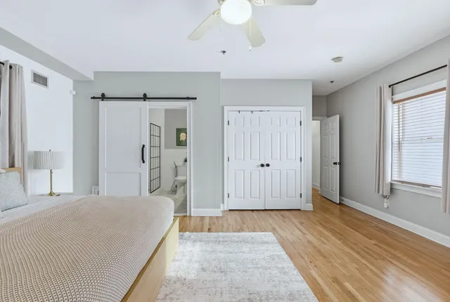 a spacious bedroom with a bed and a window