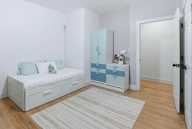 a spacious bedroom with a bed and a table in it