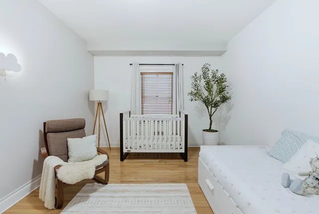 a bedroom with a couch and a chair